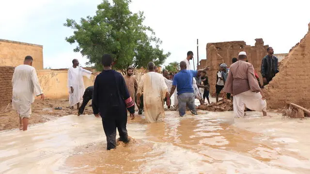 epa11567850 People stand at a flood-affected area in Masawi, the northern state of Merowe, Sudan, 27 August 2024. According to the United Nations Office for the Coordination of Humanitarian Affairs (OCHA) in Sudan, at least 30 people have died after the Arba'at Dam, located approximately 38 km northwest of Port Sudan in Sudan's Red Sea State, was extensively damaged on 25 August due to heavy rains. Some 50,000 people living on the western side of the Dam have been severely affected, according to local authorities. OCHA figures state the floods affecting Sudan since July 2024 had already displaced at least 118,000 people prior to the dam collapse, and 317,000 were already affected across 16 of the 18 Sudanese states. EPA/STR