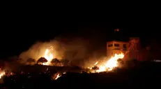 epa08564950 A fire seen from the Israeli side of the border on a Syrian observation post, caused by an Israeli army helicopters attack, on the Israeli-Syrian border next to the village of Majdal Shams, late 24 July 2020. An Israeli army spokesperson announced that Israeli helicopters struck military targets in southern Syria belonging to the Syrian Armed Forces. A number of targets were struck, including SAF observation posts and intelligence collection systems located in SAF bases. EPA/ATEF SAFADI