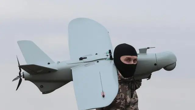 epa11155595 A Ukrainian serviceman from the 108th Brigade of Territorial Defence carries a Ukraine-made multi-purpose drone Leleka-100 on a field near a frontline in the direction of Zaporizhzhia, Ukraine, 15 February 2024, amid the Russian invasion. Russian troops entered Ukrainian territory on 24 February 2022, starting a conflict that has provoked destruction and a humanitarian crisis. EPA/KATERYNA KLOCHKO