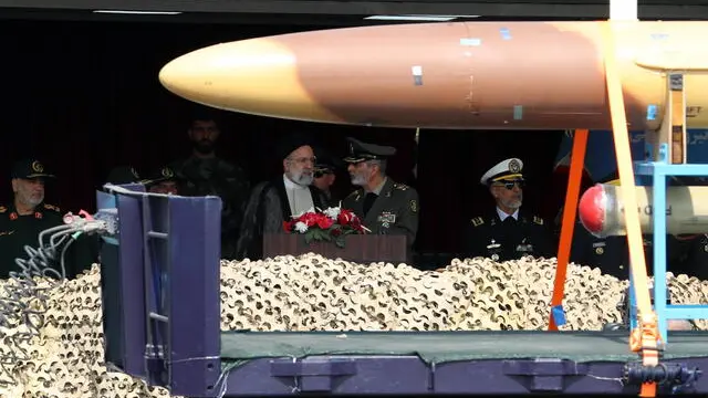 epa11283757 Iranian President Ebrahim Raisi (C-L) watches as a drone passes during the annual Army Day in a military base in Tehran, Iran, 17 April 2024. According to Iranian state media, Raisi described the recent attack launched towards Israel as 'limited' and 'punitive', adding that any act of aggression against Iran will be dealt with a 'powerful and fierce' response. Iran's Islamic Revolutionary Guards Corps (IRGC) launched drones and rockets towards Israel late on 13 April. EPA/ABEDIN TAHERKENAREH