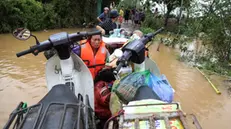 epa11596100 Local residents are evacuated on a boat at a flooded street in Hanoi, Vietnam, 10 September 2024. Typhoon Yagi, which struck northern Vietnam over the weekend, triggered severe flooding in Hanoi. The Red River's rapid rise inundated communities along the riverbank, forcing residents to seek refuge in safer areas. As of 09 September, the Vietnam Disaster and Dyke Management Authority reported at least 65 fatalities and 39 missing persons due to the typhoon. According to UNICEF, millions of families were affected by the widespread flooding and landslides caused by Yagi when it made landfall on 07 September. EPA/LUONG THAI LINH