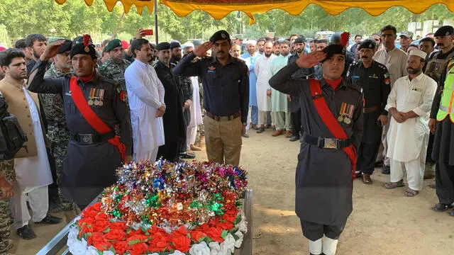 epa11598234 District Police Officer of Bajaur Waqas Rafique (C) lays a wreath during the funeral of a police officer who was killed after an attack by suspected militants during a polio vaccination campaign near the Afghan border in Bajaur, Pakistan, 11 September 2024. A polio vaccination team was attacked by suspected militants, near the Afghan border in Bajaur district, Khyber Pakhtunkhwa, resulting in the deaths of a polio worker and a police officer providing security. The police cordoned off the area and initiated a search operation for the attackers, while the bodies were taken to Khar Hospital. This incident highlights the ongoing violence aimed at disrupting polio eradication efforts in the region, despite existing security measures. EPA/HANIFULLAH KHAN