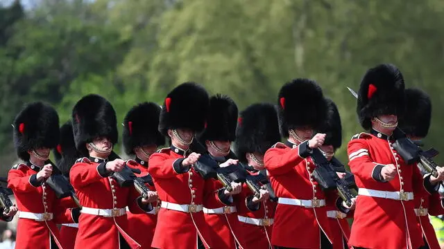 epa09906852 The Grenadier Guards perform the Changing of the Guard outside Buckingham Palace in London, Britain, 24 April 2022. The Changing of the Guard is a traditional military ceremony carried out daily where a group of soldiers who protect Buckingham Palace are replaced by a new group of soldiers. The Grenadier guards have protected British Kings and Queens at various royal palaces since 1656. EPA/ANDY RAIN