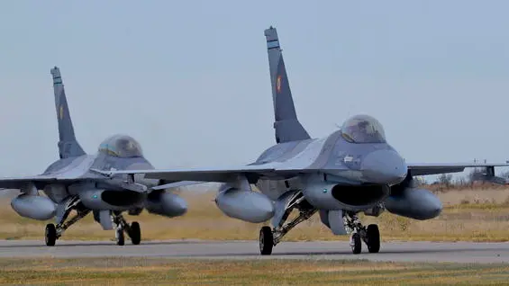 epa10973336 Two Romanian military jets taxi after a demonstration following the opening ceremony for the European F-16 Training Center, held at the 86th Air Base 'Lieutenant Aviator Gheorghe Mociornita', in Borcea, Romania, 13 November 2023. The ETFC it is the first European dedicated training facility outside the United States territory that had all the means for training F16 pilots in order to facilitate the interoperability between NATO member countries. According to the project contract, Romanian Defense Ministry put the 86th Air Base at the training hub's disposal, including the tech training facilities and logistic support. The Netherlands already gave four pieces of F16 jet fighters for the training flights, and US company Lockheed Martin comes with the instructors and maintenance. At the EFTC are supposed to get the training the Ukrainian pilots that will handle the F16 that Ukraine will receive from its western allies, according to the NATO decision. EPA/Robert Ghement