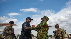 epa11601123 Kenyan Police Commander Godfrey Otunge (2-R) greets a policeman upon his arrival at Toussaint Louverture International Airport in Port-au-Prince, Haiti, 12 September 2024. The first Jamaican and Belizean troops for the Multinational Security Support Mission have arrived in Port-au-Prince and will join the 400 Kenyan agents, the country leading the operation, who are already in Haiti. EPA/Johnson Sabin