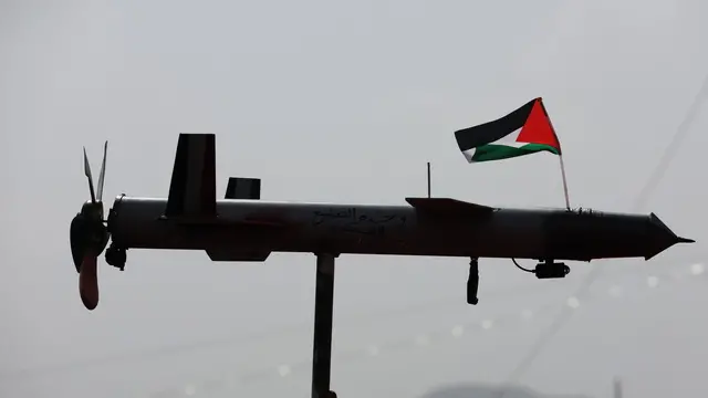 epaselect epa11573862 A Houthi supporter holds up a mock drone with a Palestinian flag during an anti-US and Israel protest, in Sana'a, Yemen, 30 August 2024. Thousands of people participated in the protest in solidarity with the Palestinian people and condemning the US support for Israel's military operation in the Gaza Strip, amid the Houthis' maritime attacks in the seas around Yemen. The Houthis have vowed a surprise response to Israeli attacks that targeted a month ago with several raids at the Hodeidah port and fuel tanks in the coastal Yemeni city of Hodeidah, according to a televised address by the Houthis' leader Abdul-Malik al-Houthi. EPA/YAHYA ARHAB