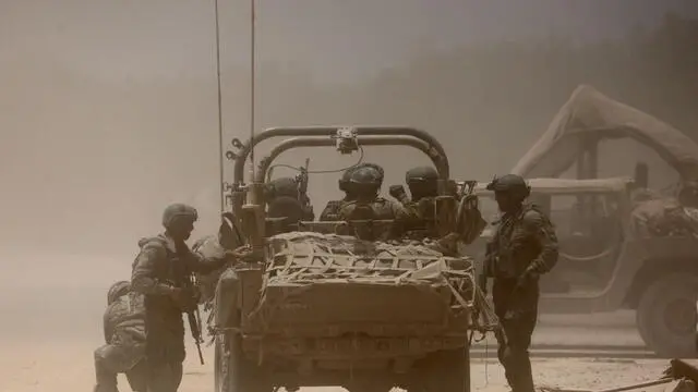 epa11452021 Israeli soldiers with a military vehicle at an undisclosed location near the border with the Gaza Strip, southern Israel, 02 July 2024. The Israeli military stated on 02 July that it continued operations in the areas of Shejaiya, Rafah, and central Gaza. More than 37,000 Palestinians and over 1,400 Israelis have been killed, according to the Palestinian Health Ministry and the Israel Defense Forces (IDF), since Hamas militants launched an attack against Israel from the Gaza Strip on 07 October 2023, and the Israeli operations in Gaza and the West Bank which followed it. EPA/ABIR SULTAN