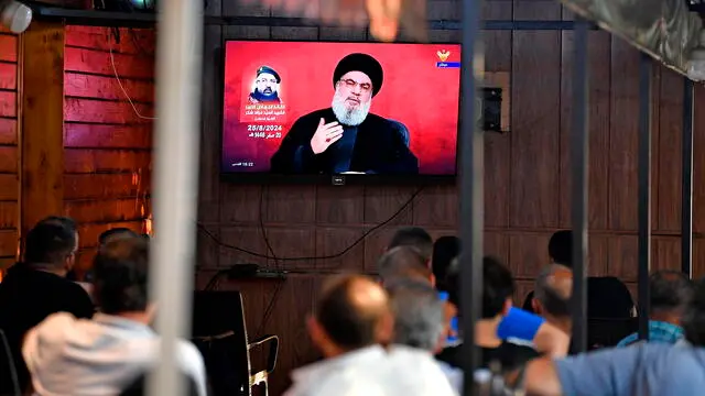 epa11564623 People watch Hezbollah Secretary-General Hassan Nasrallah delivering a televised speech at a coffee shop in the southern suburb of Beirut, Lebanon, 25 August 2024. Hezbollah announced in a statement early on 25 August that the group launched 'an aerial operation with numerous drones' targeting Israeli territory as the 'phase one' of a retaliatory attack for the killing of senior Hezbollah commander Fuad Shukr, on 30 July in Beirut. The Israeli Defense Forces (IDF) said some 100 fighter jets 'struck and destroyed thousands of Hezbollah rocket launcher barrels, aimed for immediate fire toward northern and central Israel'. EPA/ABBAS SALMAN