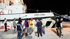 The ship Open Arms in the port of Lampedusa, 21 August 2019. In the dock doctor Francesco Cascio (R-with mask), the head of the Lampedusa Clinic, visits the refugees, then they are invited to board the buses that, as soon as the procedures are finished, will take them to the hotspot. ANSA / ELIO DESIDERIO