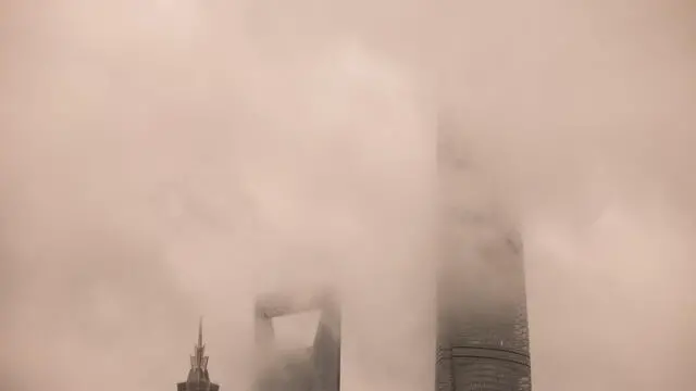 epa11607729 Lujiazui financial district skyline is seen during the heavy wind and rain amid Typhoon Bebinca in Shanghai, China, 16 September 2024. Shanghai, China's financial hub, closed its seaports and canceled over 600 flights in preparation for Typhoon Bebinca, the strongest tropical storm to hit the city in 75 years. More than 377,000 people were evacuated, and the Mid-Autumn Festival's mood has been dampened by the potential for up to 10 inches (25 cm) of rain. EPA/ALEX PLAVEVSKI