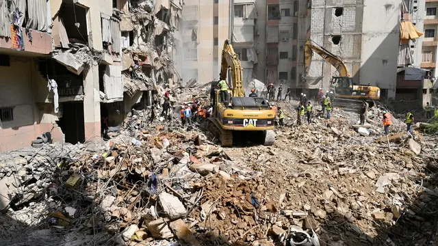 epaselect epa11616853 Emergency workers use excavators to clear the rubble at the site which was targeted by an Israeli strike the previous day, in the southern suburb of Beirut, Lebanon, 21 September 2024. At least thirty-one people, including Hezbollah commander Ibrahim Akil, were killed and dozens injured in an attack which targeted the southern suburb of Beirut, according to the Lebanese Ministry of Health. The Israeli military stated on 20 September that it conducted a 'targeted strike' in Beirut, claiming that the 'Hezbollah Commanders we eliminated today' had been planning attacks on northern areas of Israel. EPA/WAEL HAMZEH