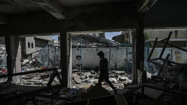 epa11600152 An internally displaced Palestinian boy walks among the rubble at the UNRWA-run school-turned-shelter of al-Jaouni, a day after the structure was hit by an Israeli airstrike, in Al-Nusairat refugee camp, central Gaza Strip, 12 September 2024. According to the Palestinian Ministry of Health in Gaza, at least 18 Palestinians were killed and dozens were injured in the strike. The United Nations agency for Palestine refugees (UNRWA) said at least six of their workers were among the victims. The Israeli military stated that it conducted a 'precise strike' on militants operating inside a Hamas command and control center in the area of Nuseirat in central Gaza. More than 41,000 Palestinians and over 1,400 Israelis have been killed, according to the Palestinian Health Ministry and the Israel Defense Forces (IDF), since Hamas militants launched an attack against Israel from the Gaza Strip on 07 October 2023, and the Israeli operations in Gaza and the West Bank which followed it. EPA/MOHAMMED SABER