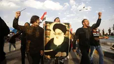 epa08200796 Iraqi protesters carry a picture of Iraqi Shiite Muslim spiritual leader Sayyid Ali Husseini Sistani during a protest in Basra city, southern Baghdad, Iraq, 07 February 2020. The United Nations Assistance Mission to Iraq (UNAMI) and the US embassy in Iraq have condemned the killing of 12 protesters in Najaf, after the supporters of Shia leader Muqtada al-Sadr stormed protests camp to forcibly remove demonstrators from the site. EPA/STR