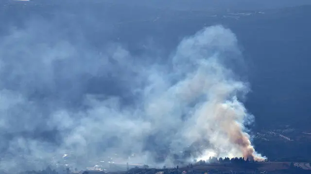 epa11611959 Smoke rises as a result of projectiles fired from southern Lebanon over Kiryat Shmona, northern Israel, 18 September 2024. The Israeli military stated that several missiles fired from Lebanon crossed into Israeli territory and were intercepted by the Iron Dome air defense system. EPA/ATEF SAFADI