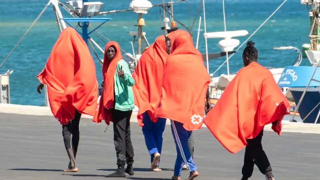 epa11623987 Migrants react upon their arrival at Arrecife's port, in Lanzarote, Canary Islands, Spain, 25 September 2024. Some 43 migrants were rescued by 'Cima de Oro' vessel as they were trying to reach the island on a small dugout. EPA/ADRIEL PERDOMO