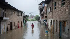 epa11462145 A person wades through a flooded street caused by the swollen Bagmati River after torrential rains in Kathmandu, Nepal, 06 July 2024. Nepal's National Disaster Risk Reduction and Management Authority (NDRRMA) warned of heavy monsoon rains that put several parts of the country at risk of floods and landslides. According to the statement issued by NDRRMA, at least 28 people have died in monsoon-related disasters since mid-June 2024. EPA/NARENDRA SHRESTHA