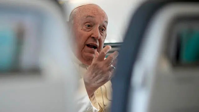 Pope Francis talks to journalists aboard on the flight back to Rome at the end of his four-day visit to Belgium and Luxembourg, Sunday, Sept. 29, 2024. (AP Photo/Andrew Medichini, Pool)