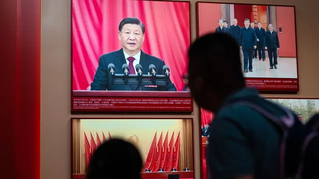 epa11631912 People look at photos of Xi Jinping, President of the People's Republic of China, in the Communist Party museum ahead of upcoming celebrations of the 75th anniversary of the founding of the People's Republic of China, in Shanghai, China, 29 September 2024. On 01 October 2024, China will celebrate the 75th anniversary of the founding of the People's Republic. EPA/ALEX PLAVEVSKI