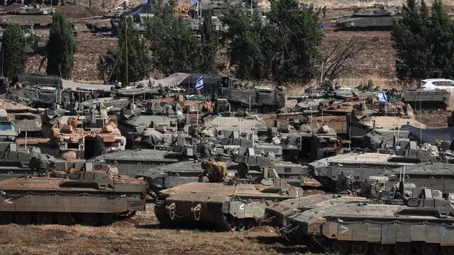 epa11633437 Israeli military vehicles at a gathering site next to the border with Lebanon as seen from an undisclosed location in northern Israel, 30 September 2024. The Israeli military announced on 30 September that it had eliminated the head of the Lebanon Branch of Hamas during an ‘overnight joining IDF and ISA intelligence-based’ operation in Lebanon.