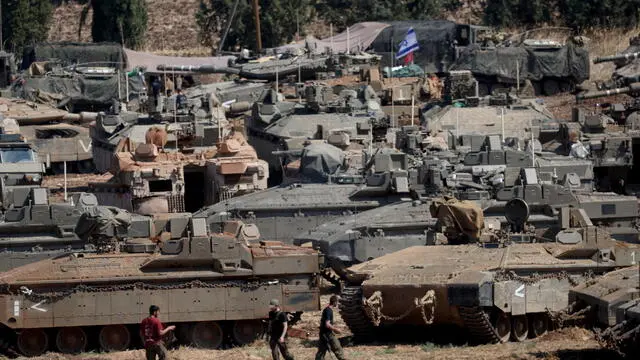 epa11633435 Israeli military vehicles at a gathering site next to the border with Lebanon as seen from an undisclosed location in northern Israel, 30 September 2024. The Israeli military announced on 30 September that it had eliminated the head of the Lebanon Branch of Hamas during an ‘overnight joining IDF and ISA intelligence-based’ operation in Lebanon.