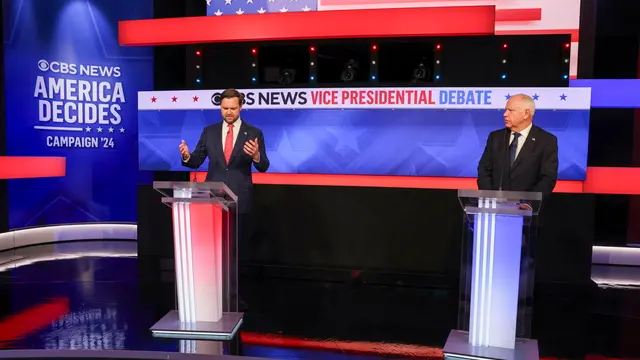 epa11636940 Republican vice presidential nominee JD Vance (L), and Minnesota Governor and Democratic vice presidential nominee Tim Walz (R) during the Vice Presidential debate at the CBS Broadcast Center in New York, New York, USA, 01 October 2024. EPA/SARAH YENESEL