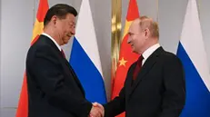 epa11455023 Russian President Vladimir Putin (R) and Chinese President Xi Jinping (L) shake hands as they pose for photos during their meeting on the sidelines of the Shanghai Cooperation Organisation (SCO) summit, in Astana, Kazakhstan, 03 July 2024. The Shanghai Cooperation Organization (SCO) summit takes place in Astana from 03 to 04 July. EPA/SERGEY GUNEEV / SPUTNIK / KREMLIN POOL MANDATORY CREDIT