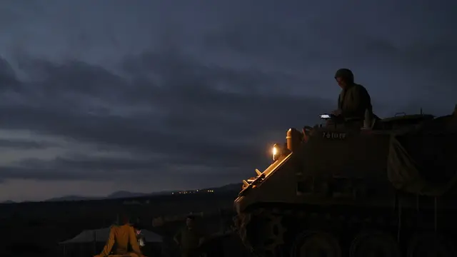 epa11614522 An Israeli female soldier sits on top of an armoured personnel carrier (APC) while waiting for transportation after a day of training in the Israeli-annexed Golan Heights, 19 September 2024. The Israeli military said they struck Hezbollah infrastructure and a weapons storage facility in multiple areas in southern Lebanon, adding that the Israeli Air Force (IAF) struck around 30 Hezbollah launchers and infrastructure sites, reportedly containing 150 launcher barrels 'ready to fire projectiles' toward Israeli territory. EPA/ATEF SAFADI