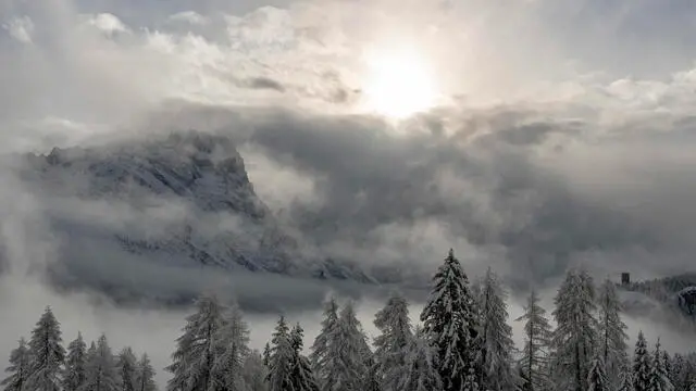 epa08995811 The sun rises over Cortina d'Ampezzo during the Alpine Skiing World Championships in Cortina d'Ampezzo, Italy, 08 February 2021. Due to heavy snowfall the Women's Alpine Combined event was cancelled earlier this day. EPA/CHRISTIAN BRUNA