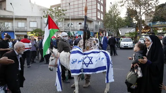 epaselect epa11280625 A donkey is dressed with Israeli flags during a celebration following Iran's attack on Israel, at the Palestine square, in Teheran, Iran, 15 April 2024. Iran's Islamic Revolutionary Guards Corps (IRGC) launched drones and rockets towards Israel late on 13 April 2024, Iranian officials said. EPA/ABEDIN TAHERKENAREH