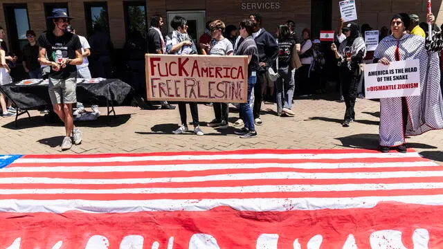 epa11643310 Protesters hold placards as they demonstrate outside the US Consulate, in Johannesburg, South Africa, 05 October 2024. The march, organized by the Palestine Solidarity Campaign (PSC), was held to express solidarity with Palestinian people, one year after the start of the Israel-Gaza conflict, and to call for an end to hostilities in the Middle East. In Cape Town, a march to the Houses of Parliament organized by the same movement was expected to draw thousands. Upcoming 07 October 2024, marks one year since the Palestinian militant group Hamas launched a surprise attack on Israel, killing 1,200, and one year since Israel began its war on Gaza, killing more than 41,000 and destroying the Palestinian enclave. EPA/KIM LUDBROOK