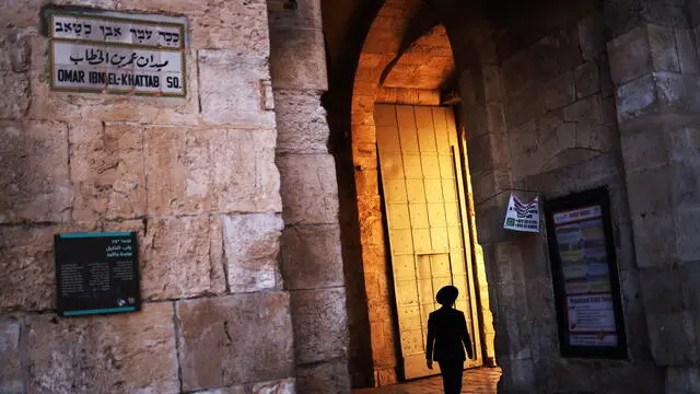 epa10962692 An orthodox member of the Jewish faith walks through the Jaffa Gate in Jerusalem, 07 November 2023. Tourism has been negatively affected due to the Israeli Palestine conflict. More than 10,000 Palestinians and at least 1,400 Israelis have been killed, according to the Israel Defense Forces (IDF) and the Palestinian health authority, since Hamas militants launched an attack against Israel from the Gaza Strip on 07 October, and the Israeli operations in Gaza and the West Bank which followed it. EPA/NEIL HALL