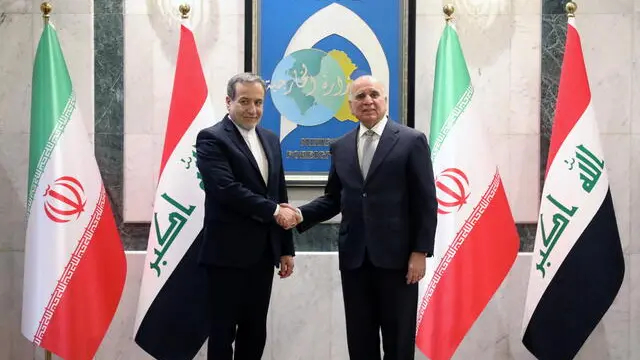 epa11657002 Iraqi Minister of Foreign Affairs Fuad Hussein (R) welcomes his Iranian counterpart Foreign Minister Abbas Araghchi (L) upon his arrival at the Iraqi Ministry of Foreign Affairs in Baghdad, Iraq, 13 October 2024. The Iranian foreign minister is in Baghdad to discuss developments in the region's security situation amid the escalation of conflict. EPA/AHMED JALIL