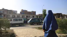 epa11564445 An Afghan woman walks on a road in Kabul, Afghanistan, 25 August 2024. The Taliban in Afghanistan have recently enforced new laws mandating that women must cover their bodies and faces in public, citing these measures as necessary to promote virtue and prevent vice, the Ministry for the Propagation of Virtue and Prevention of Vice said. Approved by their Supreme Leader Hibatullah Akhundzada, the regulations include restrictions on women's voices in public, the prohibition of images of living beings, and bans on music and mixed-gender interactions. The measures have drawn criticism from the United Nations (UN) for fostering fear and intimidation, especially among women and girls, as the Taliban's Ministry for the Propagation of Virtue and Prevention of Vice expands its control over public life. EPA/SAMIULLAH POPAL