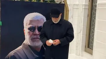 epa09690030 A handout photo made available by the Popular Mobilisation Forces media office shows the commander of the Quds Force in the Iranian Revolutionary Guards, Ismail Qaani, visiting the grave of slain Abu Mahdi al-Muhandis, commander of the Iraqi Shiite Popular Mobilisation Forces, in Najaf, Iraq, 16 January 2022. Qaani, arrived in the holy Shiite city of Najaf, south of Baghdad, on an unannounced visit. Abu Mahdi al-Muhandis and general Qasem Soleimani, the head of Iran's Islamic Revolutionary Guard Corps' elite Quds Force, were both killed in a US drone attack inside Baghdad international airport in January 2020. EPA/Popular Mobilisation Forces media office HANDOUT HANDOUT EDITORIAL USE ONLY/NO SALES