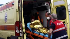 epa10694303 Paramedics of the Greek National Emergency Ambulance Service (EKAV) transfer a migrant to their ambulance, in Kalamata, Greece, 16 June 2023. The 104 people rescued after a migrant boat capsized off the coast of Pylos will be taken to a migrant reception facility in Malakasa. A total of 104 individuals were rescued, while 78 bodies were recovered, after a fishing boat capsized in international waters 47 nautical miles southwest of the Peloponnese coast and the town of Pylos. The number of people missing remains unknown. EPA/YANNIS KOLESIDIS