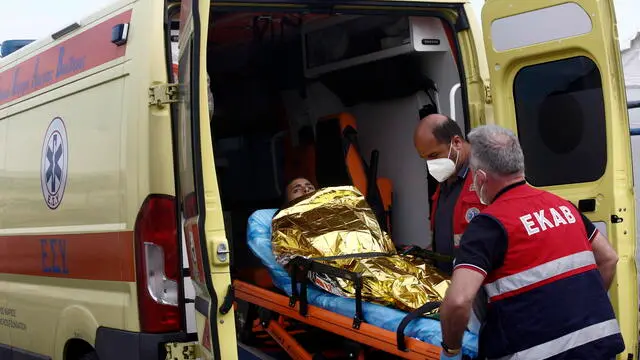 epa10694303 Paramedics of the Greek National Emergency Ambulance Service (EKAV) transfer a migrant to their ambulance, in Kalamata, Greece, 16 June 2023. The 104 people rescued after a migrant boat capsized off the coast of Pylos will be taken to a migrant reception facility in Malakasa. A total of 104 individuals were rescued, while 78 bodies were recovered, after a fishing boat capsized in international waters 47 nautical miles southwest of the Peloponnese coast and the town of Pylos. The number of people missing remains unknown. EPA/YANNIS KOLESIDIS