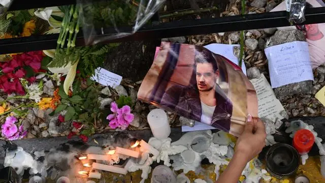 TOPSHOT - A fan pays tribute to British singer Liam Payne in front of the hotel where he died in Buenos Aires on October 17, 2024. Tributes poured in Thursday for British singer Liam Payne, a former member of the best-selling boy band One Direction, after he plunged to his death from the balcony of a Buenos Aires hotel. (Photo by Luis ROBAYO / AFP)