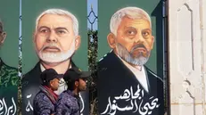 epa11666294 Houthi supporters walk past paintings showing the two late leaders of Hamas Yahya Sinwar (R) and Ismail Haniyeh during a rally in solidarity with the Lebanese and Palestinian people, one day after Hamas leader Yahya Sinwar was killed in Gaza, in Sana'a, Yemen, 18 October 2024. The Israeli Army, Tsahal, on 17 October 2024 confirmed that Hamas leader Yahya Sinwar was 'eliminated' on 16 October 'after a year-long pursuit'. Ismail Haniyeh was targeted and killed in Tehran, Iran, on 31 July 2024, the Iranian Revolutionary Guard Corps (IRGC) confirmed. Thousands of people participated in the rally in solidarity with the Lebanese and Palestinian people and to condemn the US support for Israel's military operations in Lebanon and the Gaza Strip, amid high tensions in the Middle East. EPA/YAHYA ARHAB