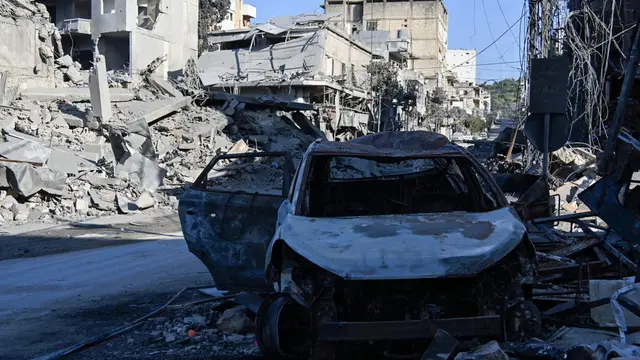 epa11666414 A damaged car sits amid destroyed buildings following an Israeli military strike on Nabatieh, southern Lebanon, 18 October 2024. The building were destroyed in the Isareli strikes of 16 October. Lebanese Ministry of Health stated that more than 2,400 people have been killed and over 11,000 have been injured in Lebanon since the start of hostilities. EPA/STR