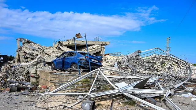 epa11666413 A damaged car sits amid destroyed buildings following an Israeli military strike on Nabatieh, southern Lebanon, 18 October 2024. The building were destroyed in the Isareli strikes of 16 October. Lebanese Ministry of Health stated that more than 2,400 people have been killed and over 11,000 have been injured in Lebanon since the start of hostilities. EPA/STR