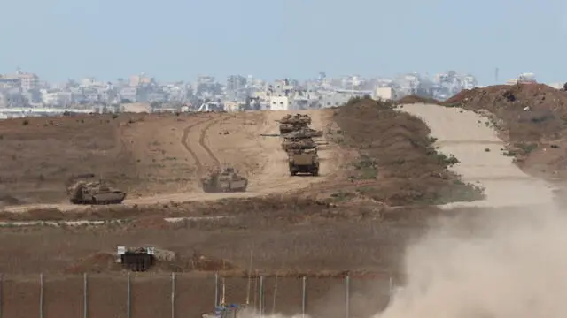 epa11645080 Israeli armoured vehicles maneuver at an area inside the northern Gaza Strip, as seen from the border with Gaza in southern Israel, 06 October 2024. Israel's military stated on 06 October, they have been conducting since last night an 'operation to systematically dismantle terrorist infrastructure' in the area of Jabalia, in the northern Gaza Strip. The Israel Air Force conducted strikes on dozens of military targets in order to assist IDF ground troops operating in the area, the statement added. EPA/ABIR SULTAN