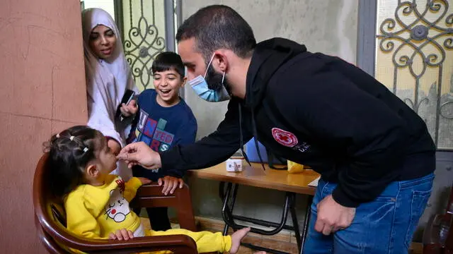 epa10301855 A Syrian child receives an Oral Cholera Vaccine from a medical worker during a vaccination campaign in the village of Bebnine, Akkar district, northern Lebanon, 12 November 2022. Cholera is an acute diarrhoeal infection that is typically spread through water and food contaminated by fecal matter due to poor wastewater management and poor hygiene practices. The oral vaccine protects people from bacteria that causes cholera. The Lebanese Ministry of Health officially declared an outbreak of cholera on 06 October 2022. Since the first case was confirmed, over 3040 suspected cases, with 521 which were laboratory-confirmed, have been reported across the country, including 18 deaths. EPA/WAEL HAMZEH