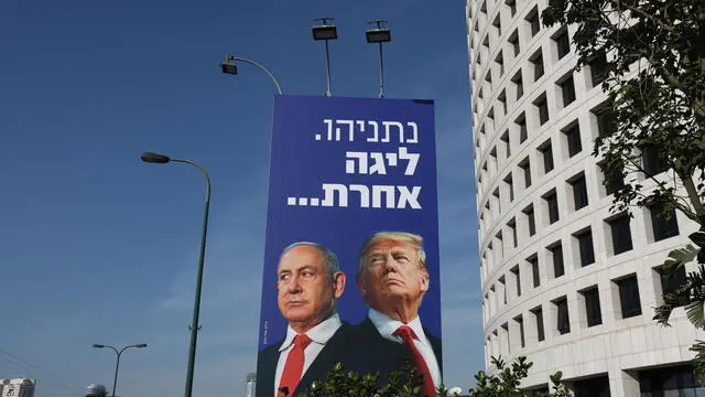 epa08933217 A billboard showing US President Donald J. Trump (R) with Israeli Prime Minister Benjamin Netanyahu with a headline reading 'Netanyahu is a different league', in Tel Aviv, Israel, 12 January 2021. Israel is expected to hold legislative elections on 23 March 2021 to elect the members of the 24th Knesset.