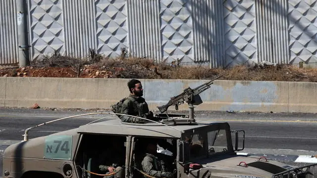 epa11654669 Israeli soldiers aboard a military vehicle at an undisclosed location, near the border with Lebanon in northern Israel, 11 October 2024. Israel's military stated on 11 October, that an anti-tank missile fired from Lebanon crossed into Israel and fell in the area of Yir'on, injuring two civilians. EPA/ATEF SAFADI