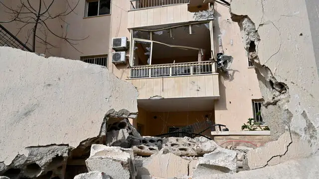 epa11174530 A damaged building that is nearby a building one day after it was targeted by an Israeli drone strike in the town of Kfar Roummane, near the town of Nabatiyeh, southern Lebanon, 23 February 2024. Lebanese state media said at least two Hezbollah fighters were killed and three others wounded after an Israeli drone launched two guided missiles on a residential building in the town of Kfar Roummane on 22 February. The Israeli army did not comment on the incident. EPA/WAEL HAMZEH