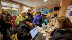 epa11664952 People who were evacuated from Kupyansk and other areas close to the frontline in the Kharkiv region, register as they arrive at an evacuation center in the city of Kharkiv, Ukraine, 17 October 2024, amid the Russian invasion. About 100 people were evacuated on 16 October, with around 250 more scheduled to be evacuated on 17 October. Since September 2024, almost 1,500 people have left Kupyansk, with about 2,500 more waiting to be evacuated, said the head of the Kharkiv Military Administration Oleg Synegubov. EPA/SERGEY KOZLOV