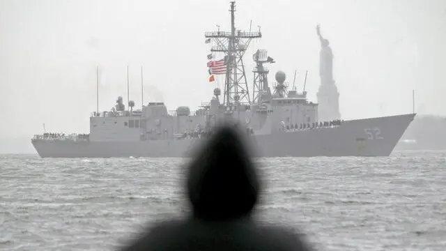 epa04534565 (FILE) A file picture dated 25 May 2005 shows a spectator watching US Navy's guided missle frigate USS Carr pass the Statue of Liberty as part of the 18th annual Fleet Week Parade of Ships in New York, USA. US President Obama on 18 December 2014 signed into law legislation authorizing the sale of up to four Perry-class warships to Taiwan. When enacted, the bill will allow the sale of guided missile frigates USS Gary, USS Carr, USS Taylor and USS Elrod to the Taiwan Navy. The four frigates were commissioned in 1984 and 1985 and are in the process of being decommissioned by the US Navy. EPA/JUSTIN LANE