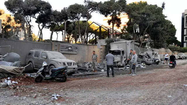 epa11672394 People inspect the site of an Israeli airstrike that targeted a branch of the Al-Qard Al-Hassan finance group in Al-Shiyah, Beirut, Lebanon, 21 October 2024. The Israeli military said the air forces conducted late on 20 October a series of targeted strikes against dozens of facilities and sites used by Al-Qard al-Hassan Association, an organization used by Hezbollah to finance its activities. The strikes were conducted in the areas of Beirut, southern Lebanon, and Baalbek. According to the Lebanese Ministry of Health, more than 2,460 people have been killed and over 11,500 others have been injured in Lebanon since the start of recent escalations of hostilities. EPA/STR