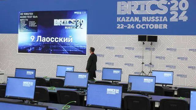 epa11672851 A worker prepares the main press-centre for the BRICS 2024 summit in Kazan Expo in Kazan, Russia, 21 October 2024. Russia will host leaders from 24 countries and delegations from 32 countries at the upcoming BRICS summit in Kazan, Russian presidential aide Yuri Ushakov said. The BRICS summit will take place from 22 to 24 October and is expected to be the largest foreign policy event ever held in Russia. EPA/MAXIM SHIPENKOV