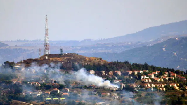 epaselect epa11439957 Smoke billows in the Israeli northern town of Metulla from cross-border rockets launched by Hezbollah from the Lebanese side, as seen from Khiam village, Lebanon, 26 June 2024. According to an Israeli army report, the IDF fighter jets on 26 June struck Hezbollah military structure and observation post and other infrastructure in the areas of Kfarchouba, Ayta ash Shab, and Khiam in southern Lebanon. Hezbollah said in statement the group targeted buildings in Metulla with 'appropriate weapons' in response to the Israeli attacks on southern villages. EPA/STR